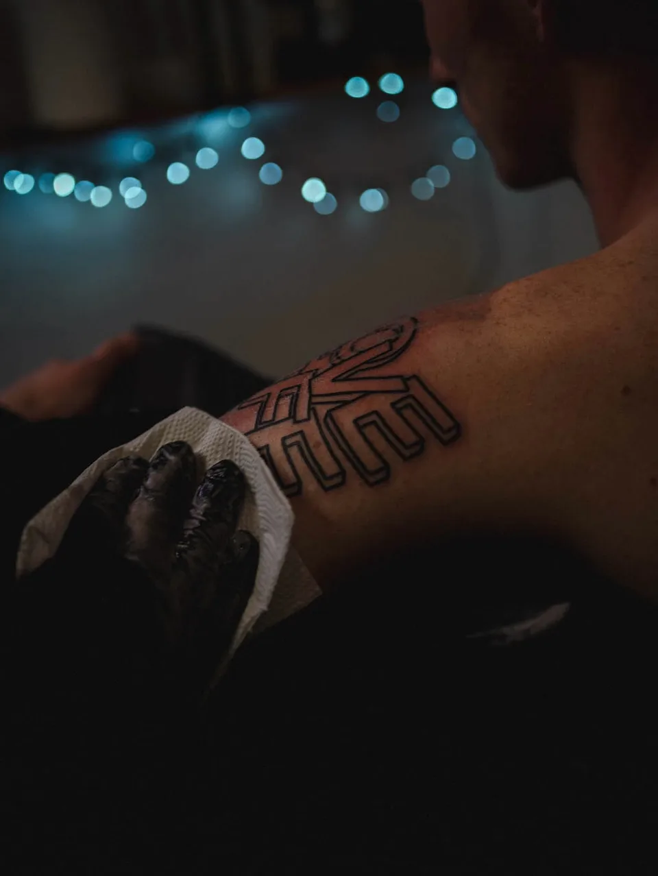Tatuator z grubo obrysowanym sleeve'em przy niebieskiej szufladzie w studio (7) — Tattoo, Wujek Darek Tattoo, Warszawa