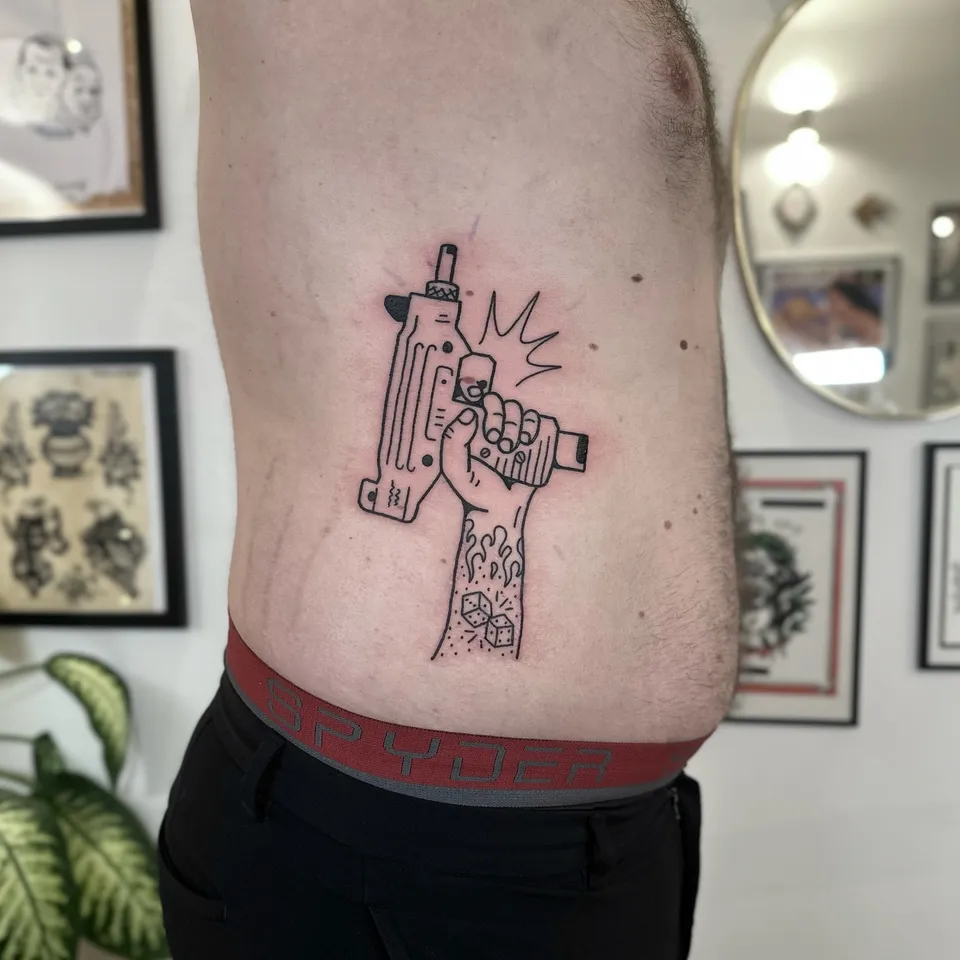 Ignorant tatuaż z ręką trzymającą Uzi na żebrach — Tattoo, Wujek Darek Tattoo, Warszawa