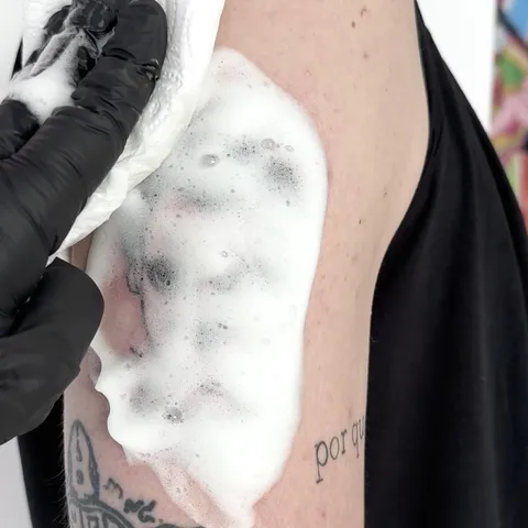 Mycie świeżego tatuażu na ramieniu po sesji — Tattoo, Wujek Darek Tattoo, Warszawa