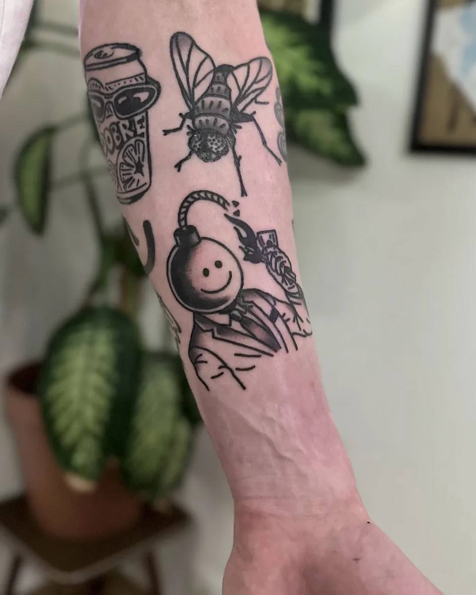 Ignorant tatuaż z bombą-smileyface, muchą i puszką na przedramieniu (2) — Tattoo, Wujek Darek Tattoo, Warszawa