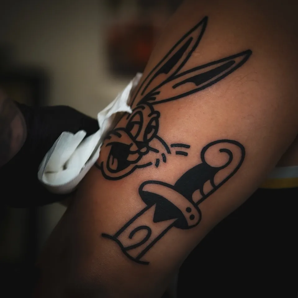 Tatuator z tatuażami na twarzy i szyi podczas pracy maszyną rotacyjną (9) — Tattoo, Wujek Darek Tattoo, Warszawa