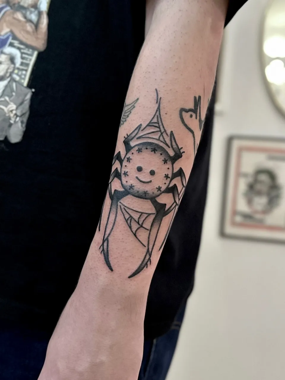 Ignorant pająk z uśmiechniętą buzią na przedramieniu — Tattoo, Wujek Darek Tattoo, Warszawa